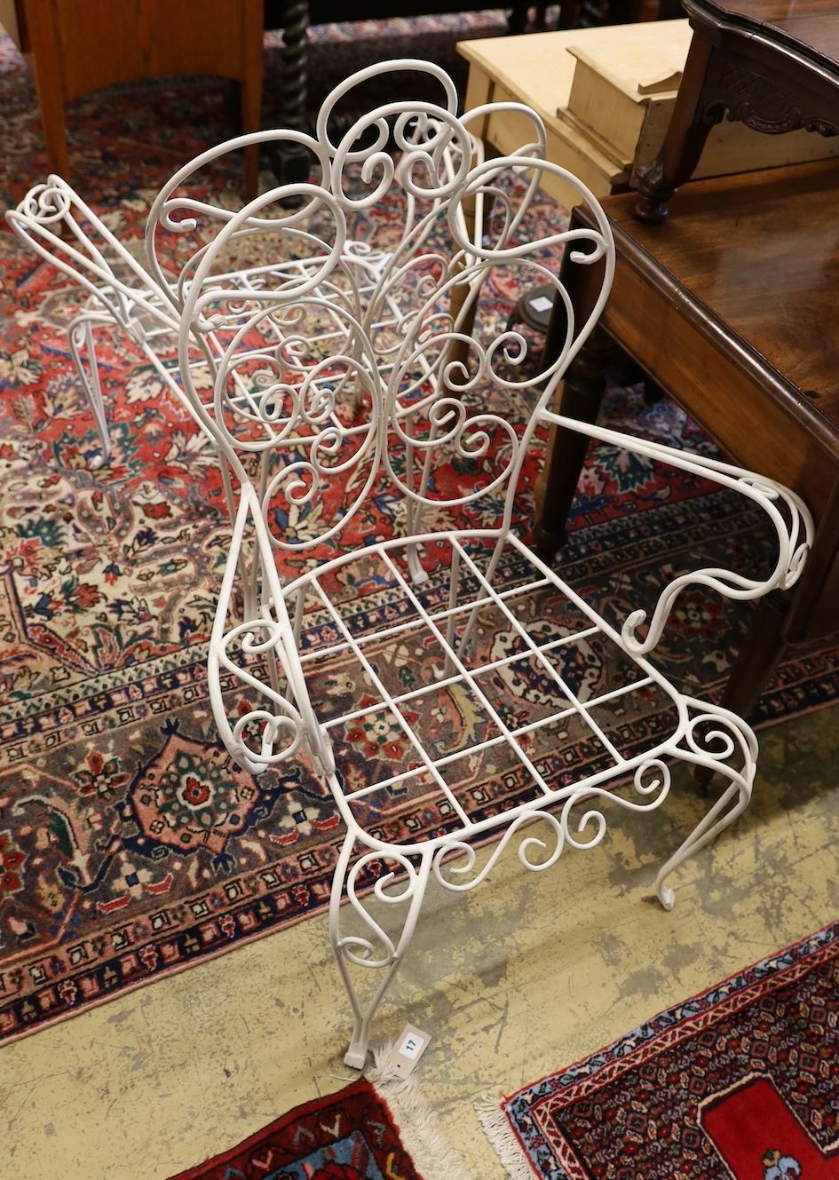 A pair of white painted wrought iron wirework garden chairs, width 74cm, height 94cm